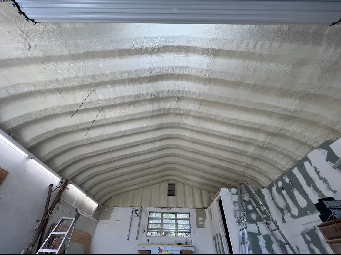 Spray polyurethane foam applied to the underside of a metal roof deck in Seneca